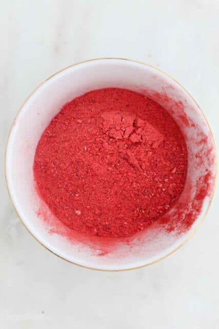 overhead of a white bowl with powdered freeze-dried strawberries