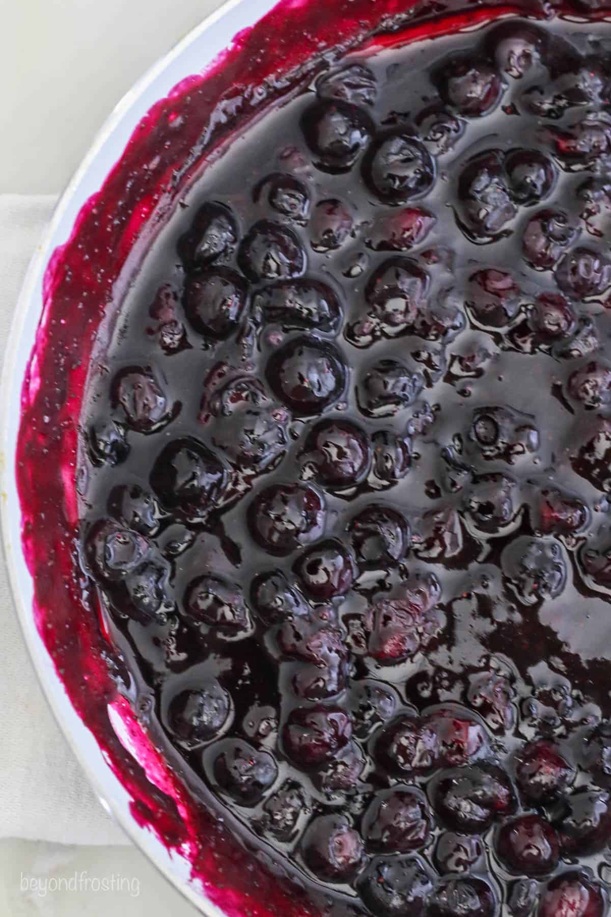 A close up of sauce pan with reduced blueberries