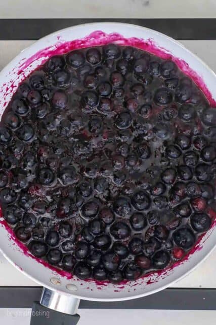 overhead shot of a saucepan filled with cooked blueberries