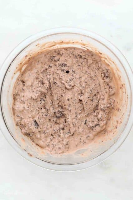 a glass mixing bowl with softened ice cream