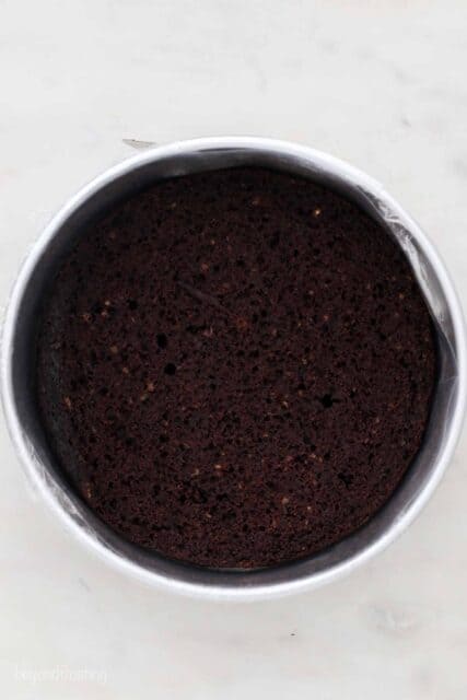 an overhead shot of a leveled cake in an aluminum pan