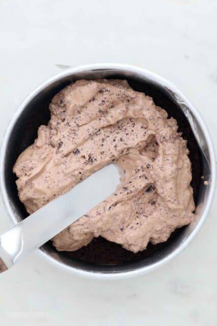 an overhead shot of a knife spreading ice cream in a pan