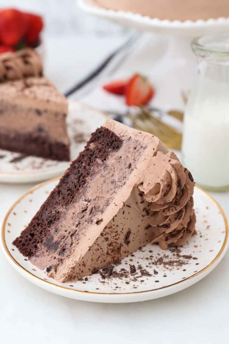 A slice of chocolate ice cream cake on a gold rimmed plate.