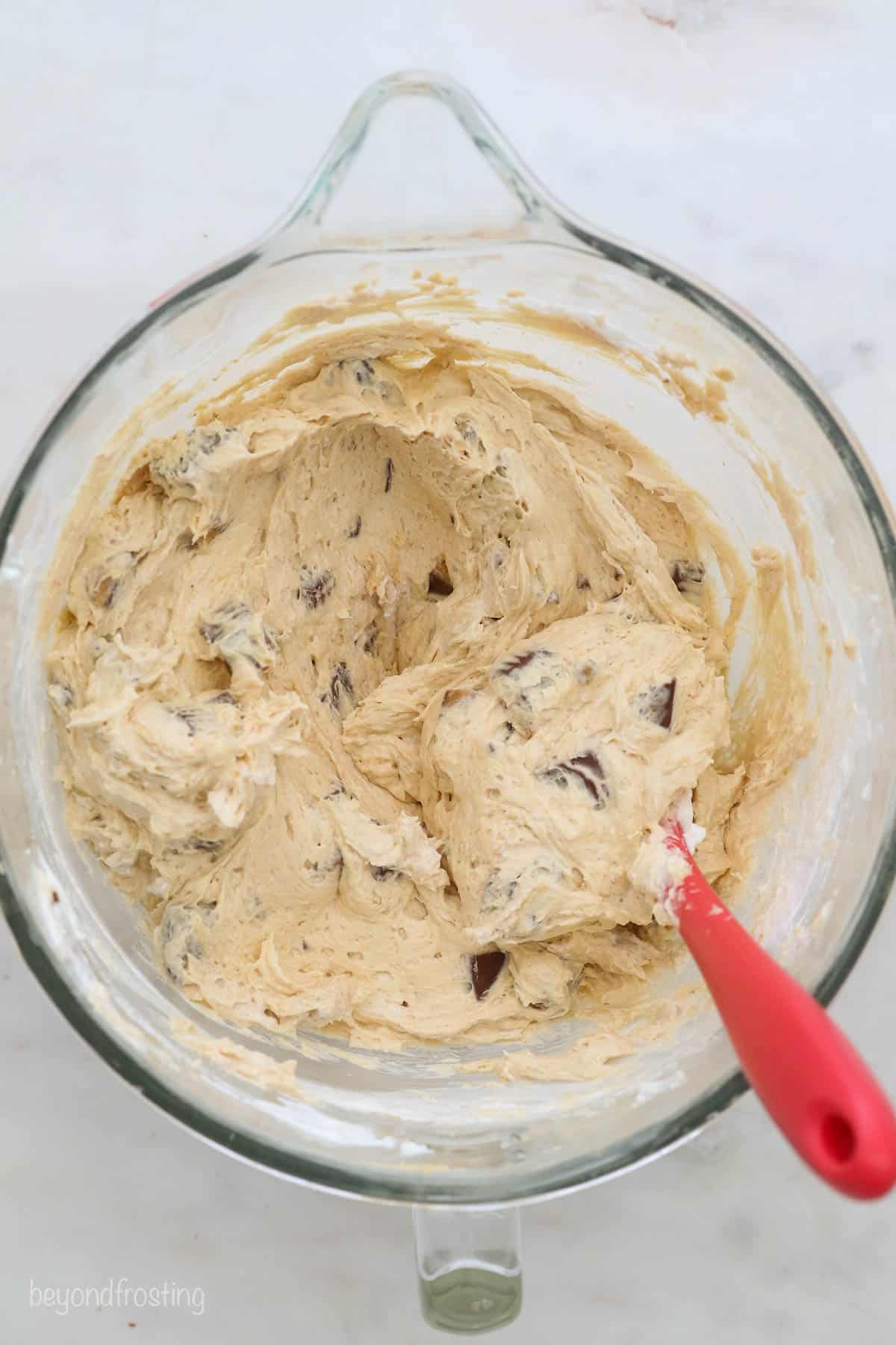 A Bird's Eye View of a glass mixing bowl with peanut butter cheesecake batter