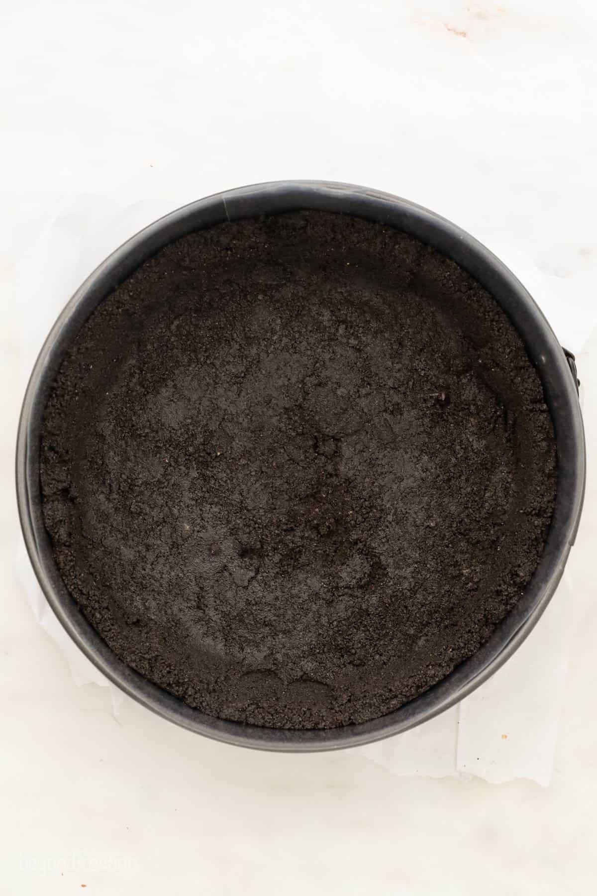A Bird's Eye View of an Oreo Cookie Crust Pressed Into a springform pan