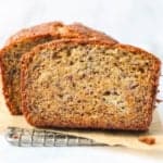 a close up of a slice of banana bread on a wire rack