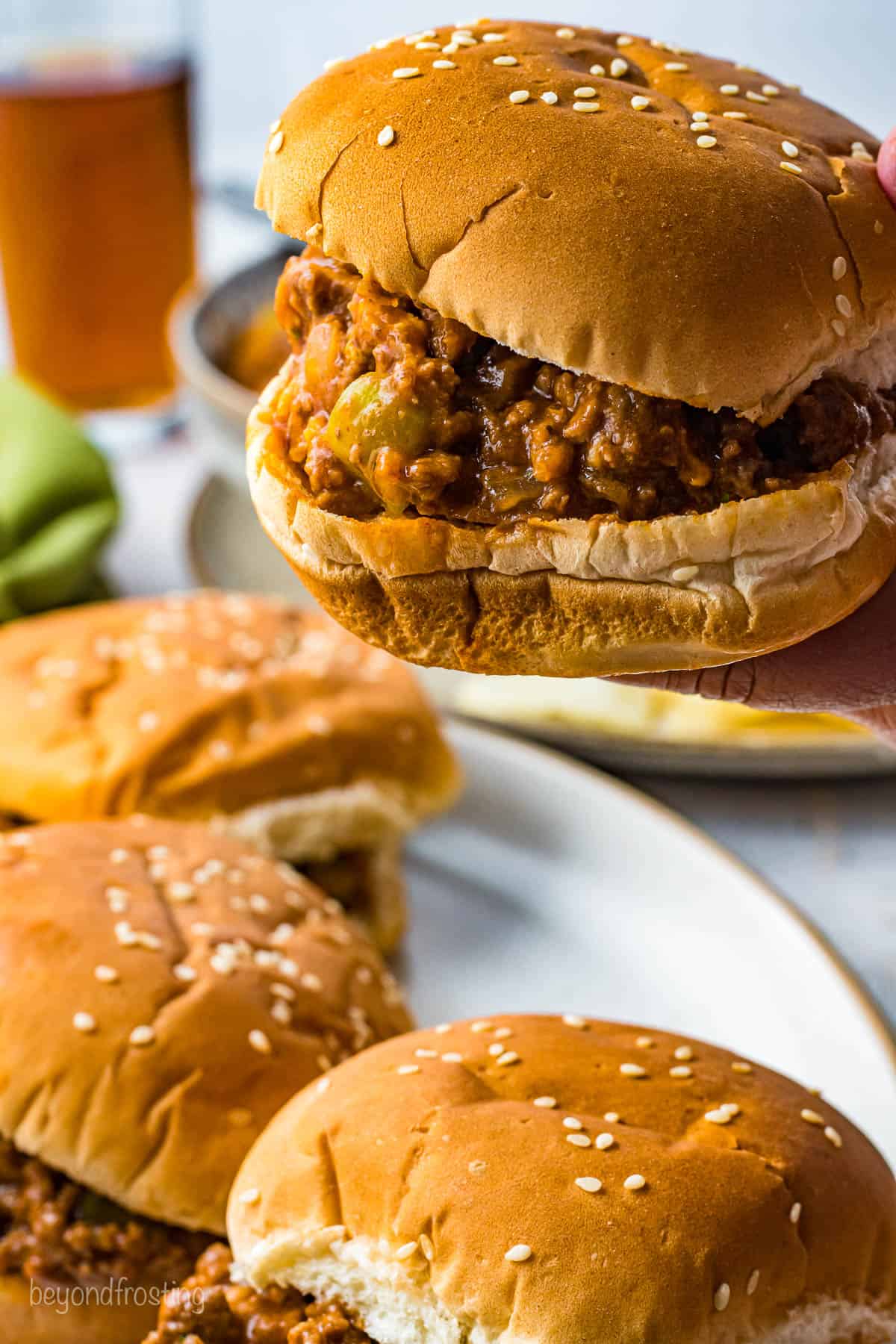 A side view of a few Sloppy Joe sandwiches.