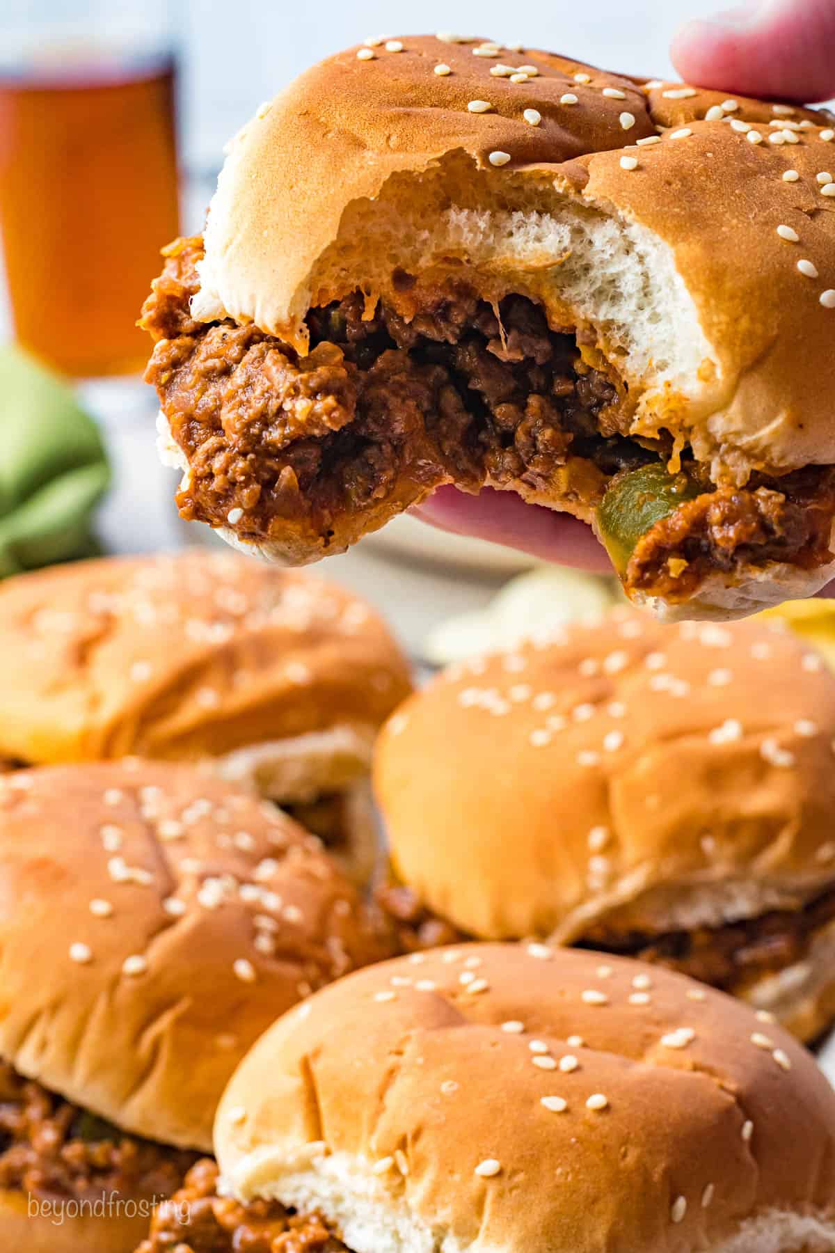 A side view of a Sloppy Joe with a bite taken out of it.