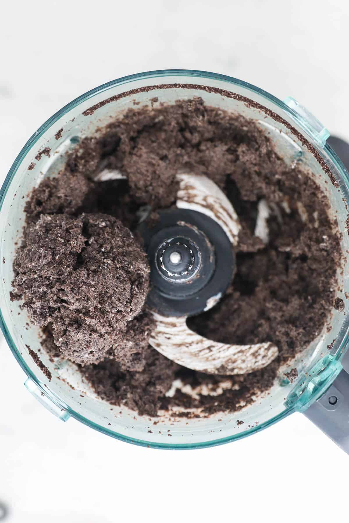 Oreo truffles come together fast, no baking required! With only 3 ingredients, these bite-sized Oreo balls make easy edible holiday gifts. Mixing the Oreo, cream cheese, and vanilla together.