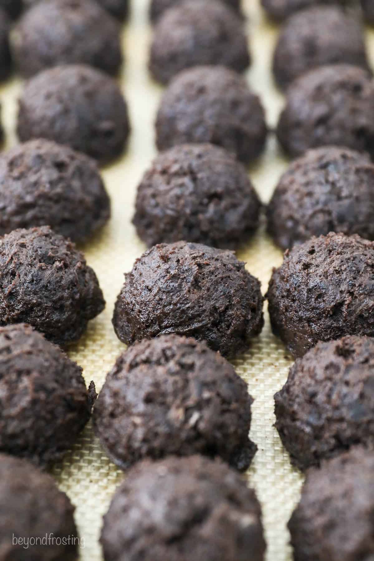Oreo truffles come together fast, no baking required! With only 3 ingredients, these bite-sized Oreo balls make easy edible holiday gifts. The Oreo mixture rolled into balls on the baking sheet.