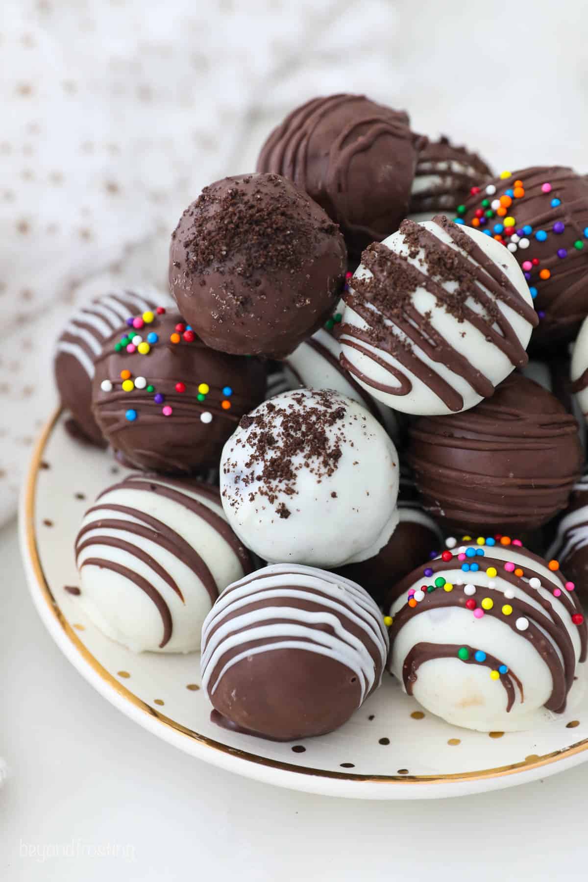 A pile of finished Oreo Truffles on a plate.