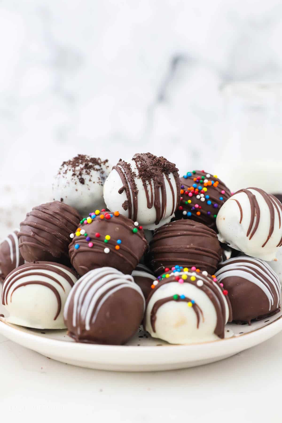 A pile of finished Oreo Truffles on a plate.