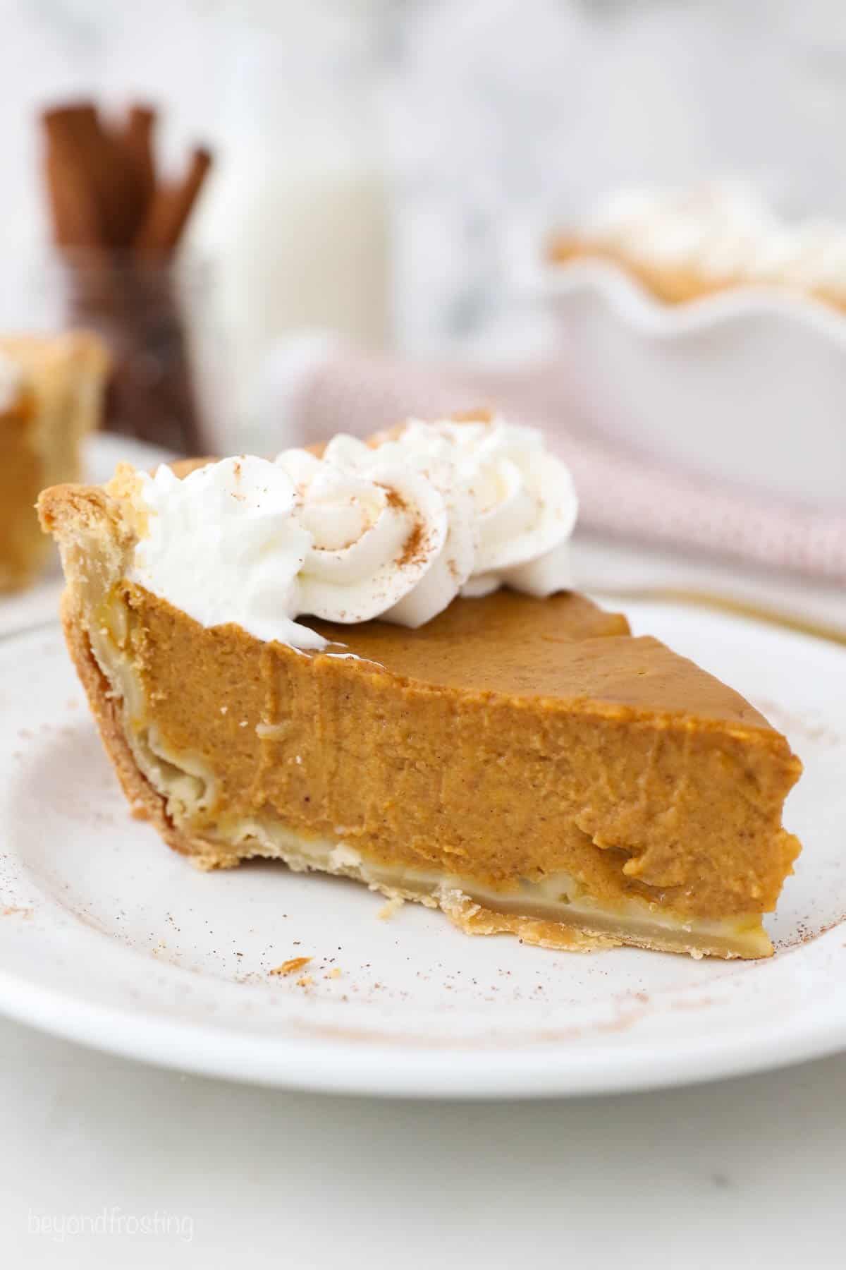 A slice of Pumpkin Pie with Homemade Whipped Cream.
