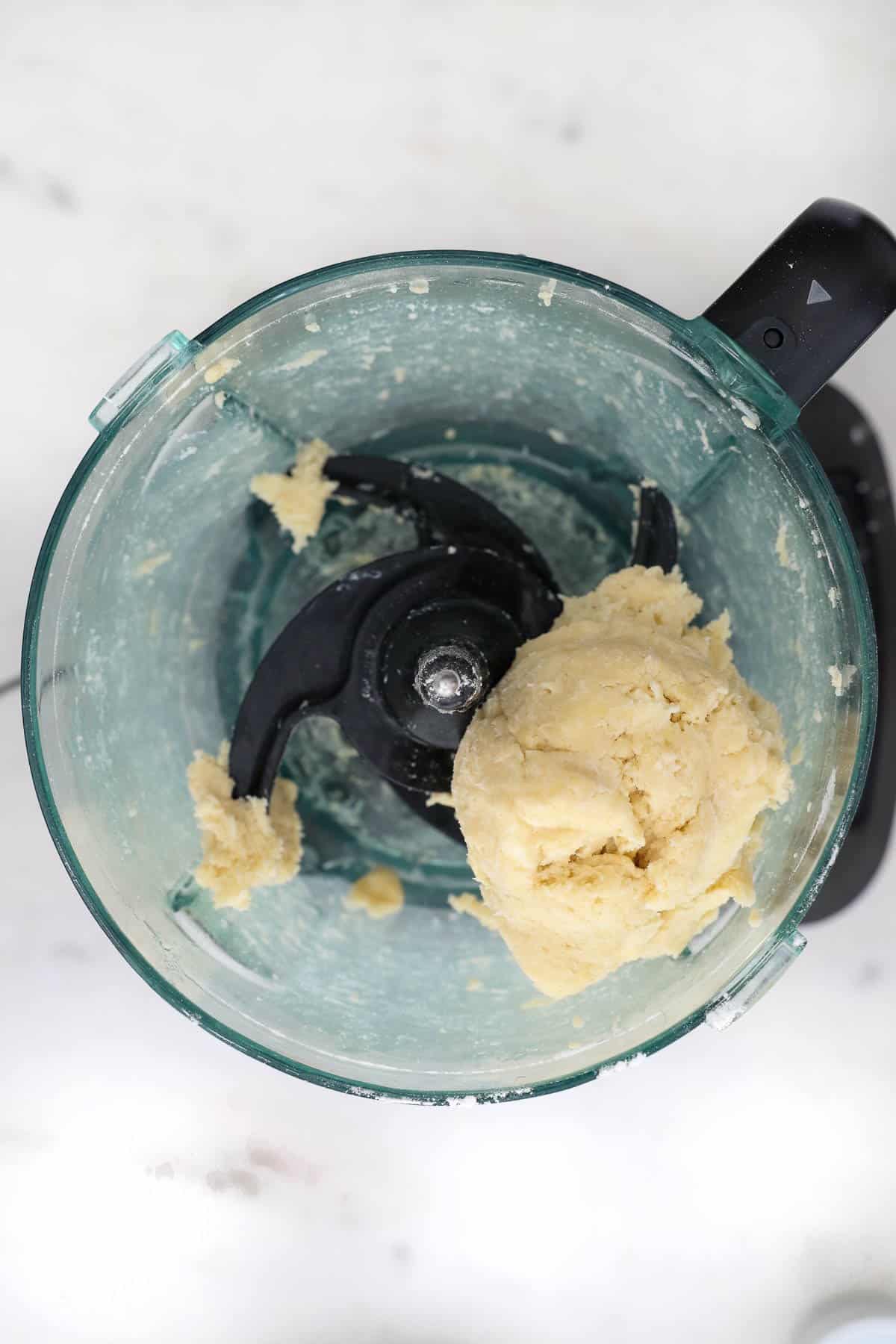 A completed crust dough inside of a food processor