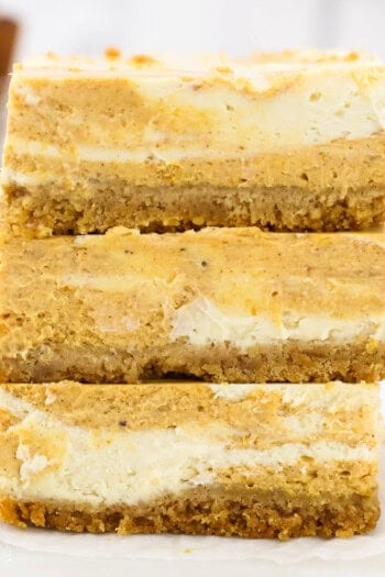 three stacked pumpkin cheesecake bars