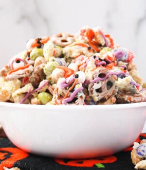 a white bowl filled with with a halloween snack mix
