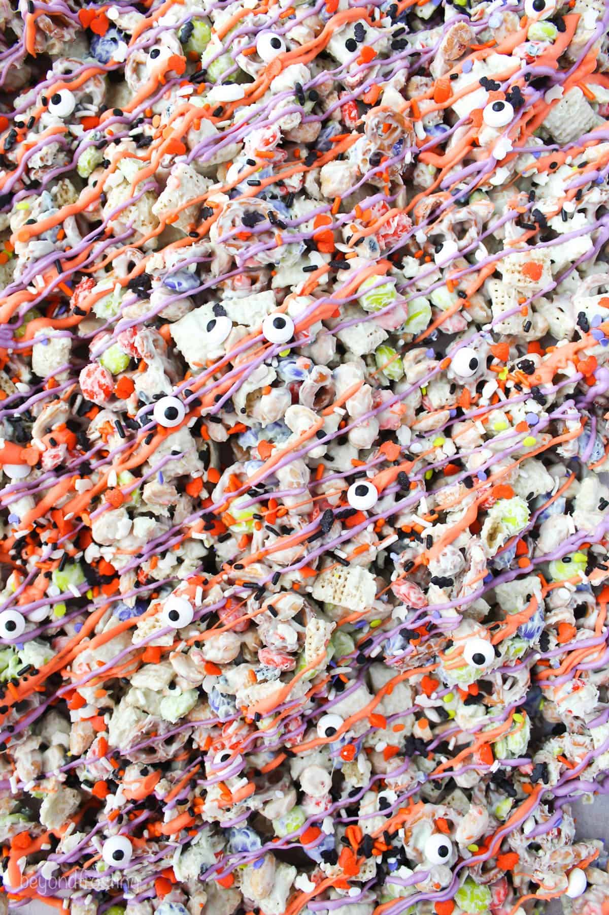 overhead shot of a white chocolate snack mix on a sheet pan