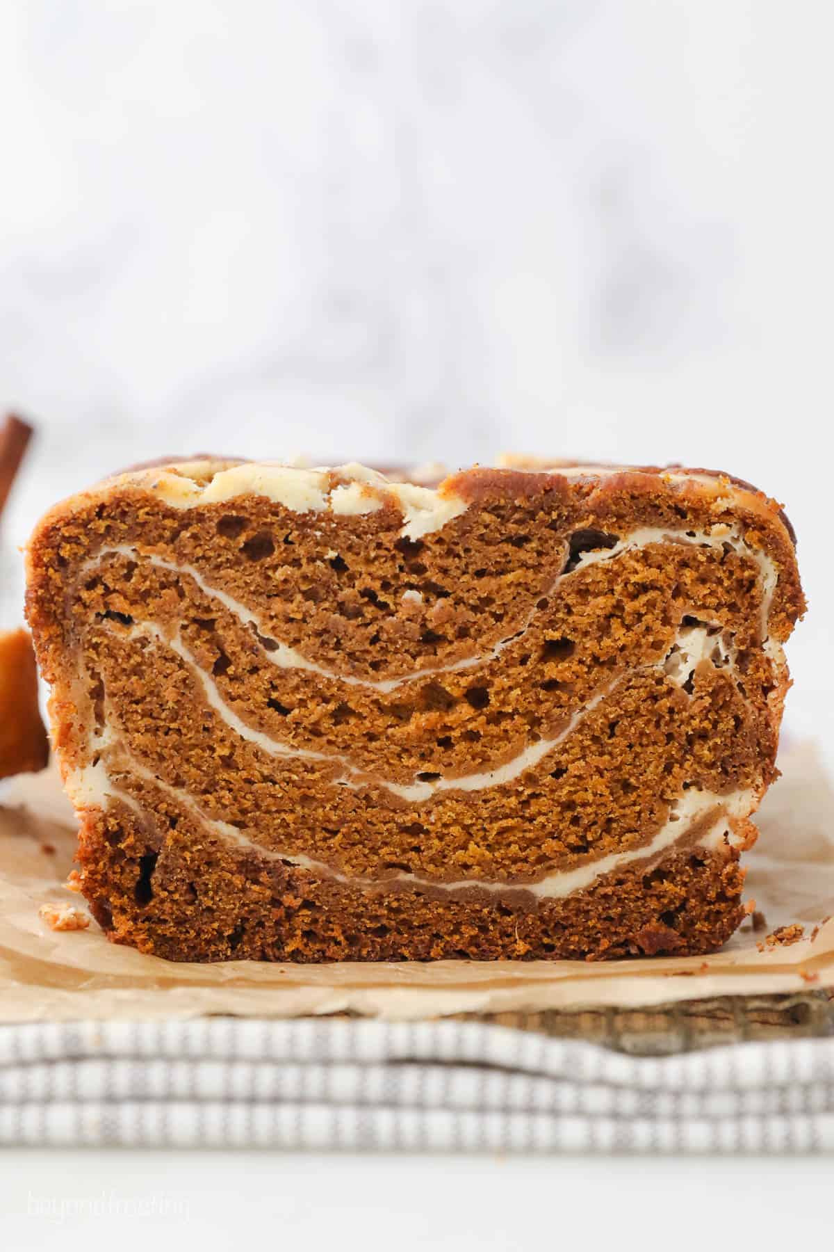 Sliced pumpkin bread on brown parchment paper