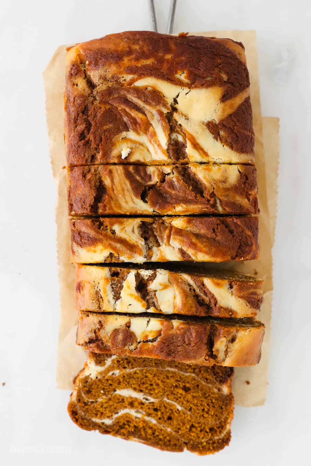 overhead shot of sliced pumpkin bread swirled with cream cheese filling
