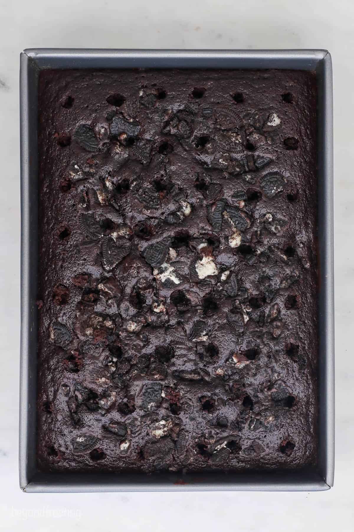 baked chocolate cake with holes poked on top