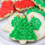 Decorated Christmas cookies with buttercream and sprinkles on a white plate