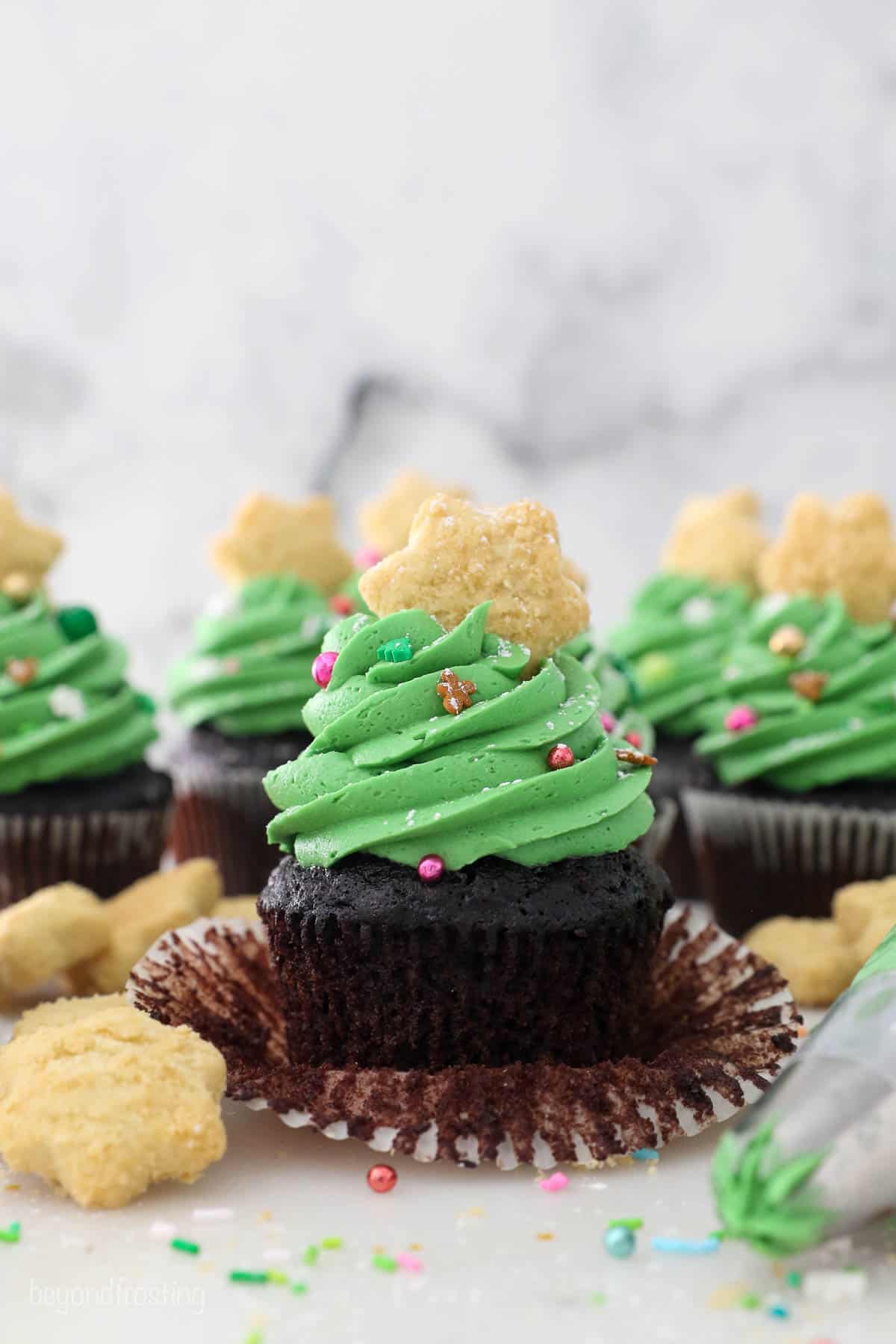 Unwrapped Chocolate Cupcake with Green frosting decorated to look like a Christmas tree
