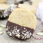 closeup of a shortbread cookie leaning on a stack of more cookies