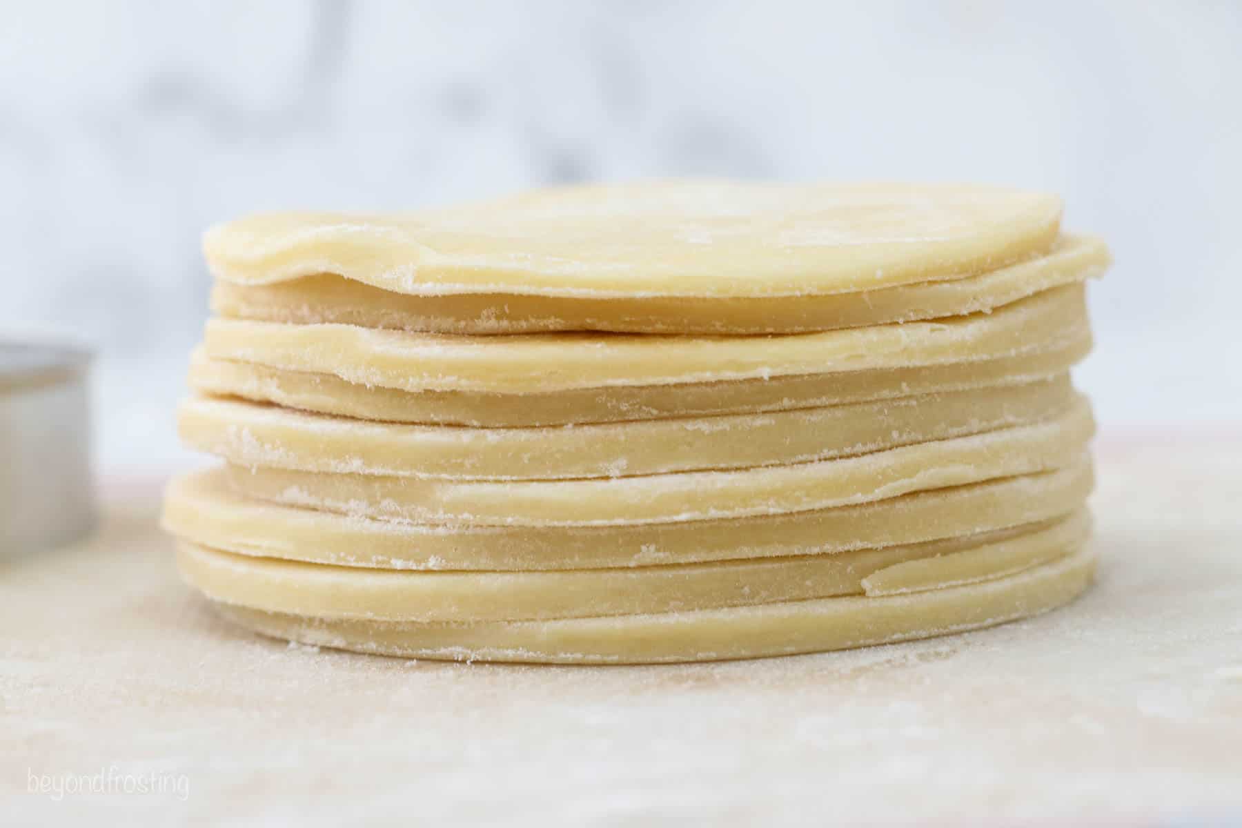 a stack of pie crusts cut into circles