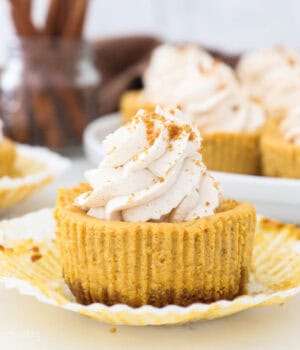 Close up of unwrapped Mini Pumpkin Cheesecake with whipped cream