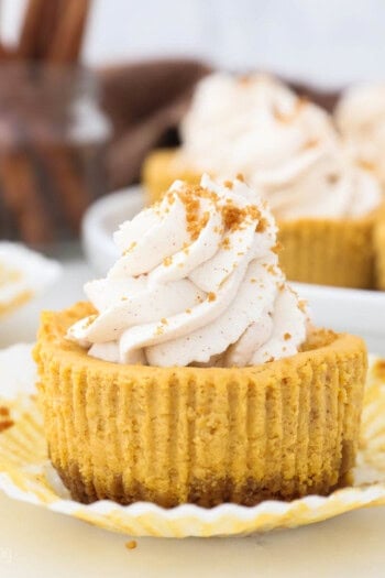 Close up of unwrapped Mini Pumpkin Cheesecake with whipped cream