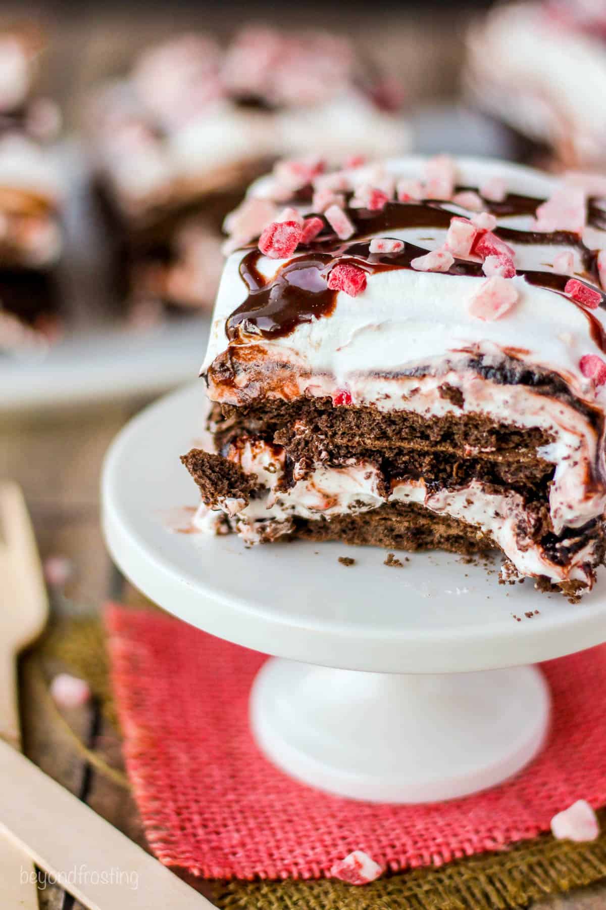 a slice of chocolate peppermint lasagna on a white serving platter