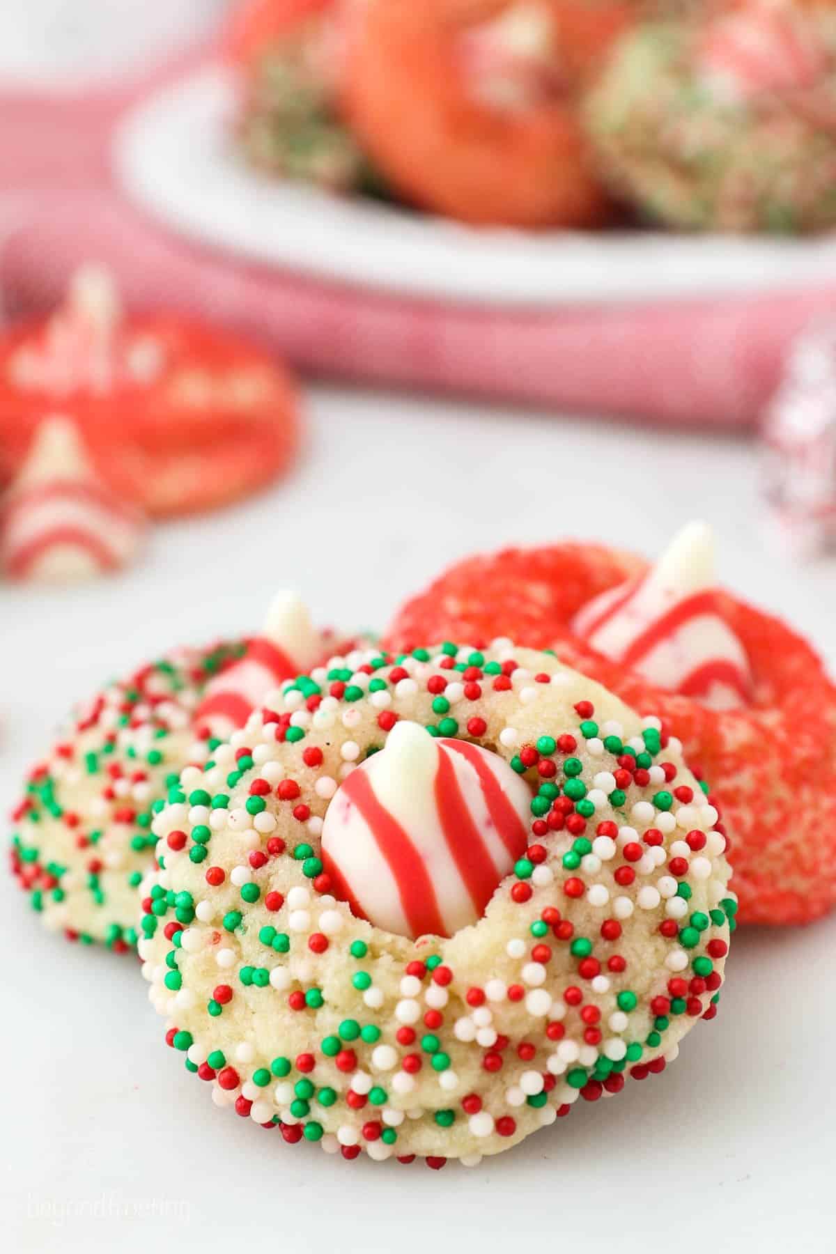 three peppermint kiss cookies leaning on one another