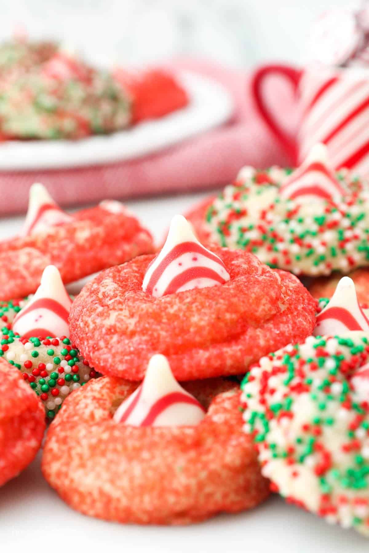 peppermint cookies coated in festive sprinkles piled on a plate