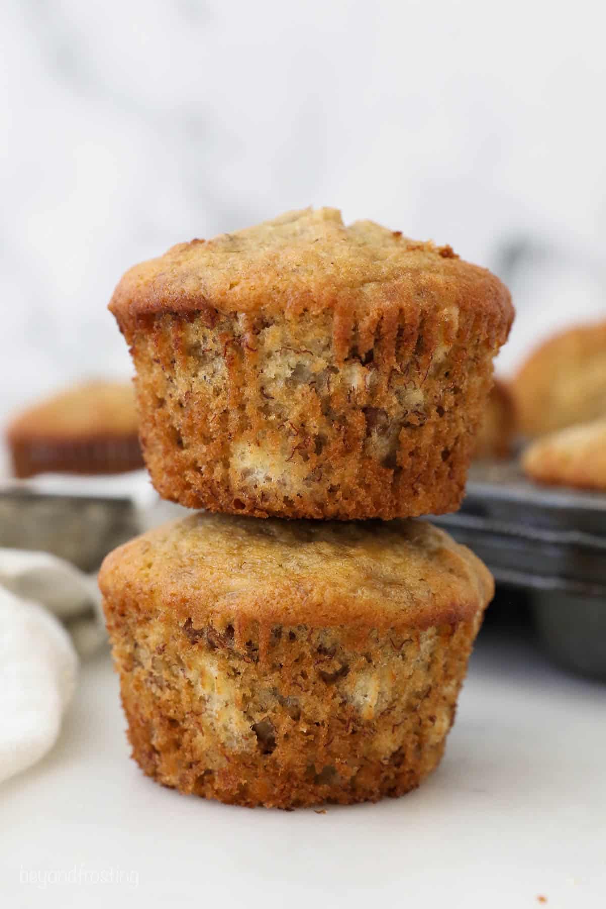Two banana nut muffins stacked on top of one another