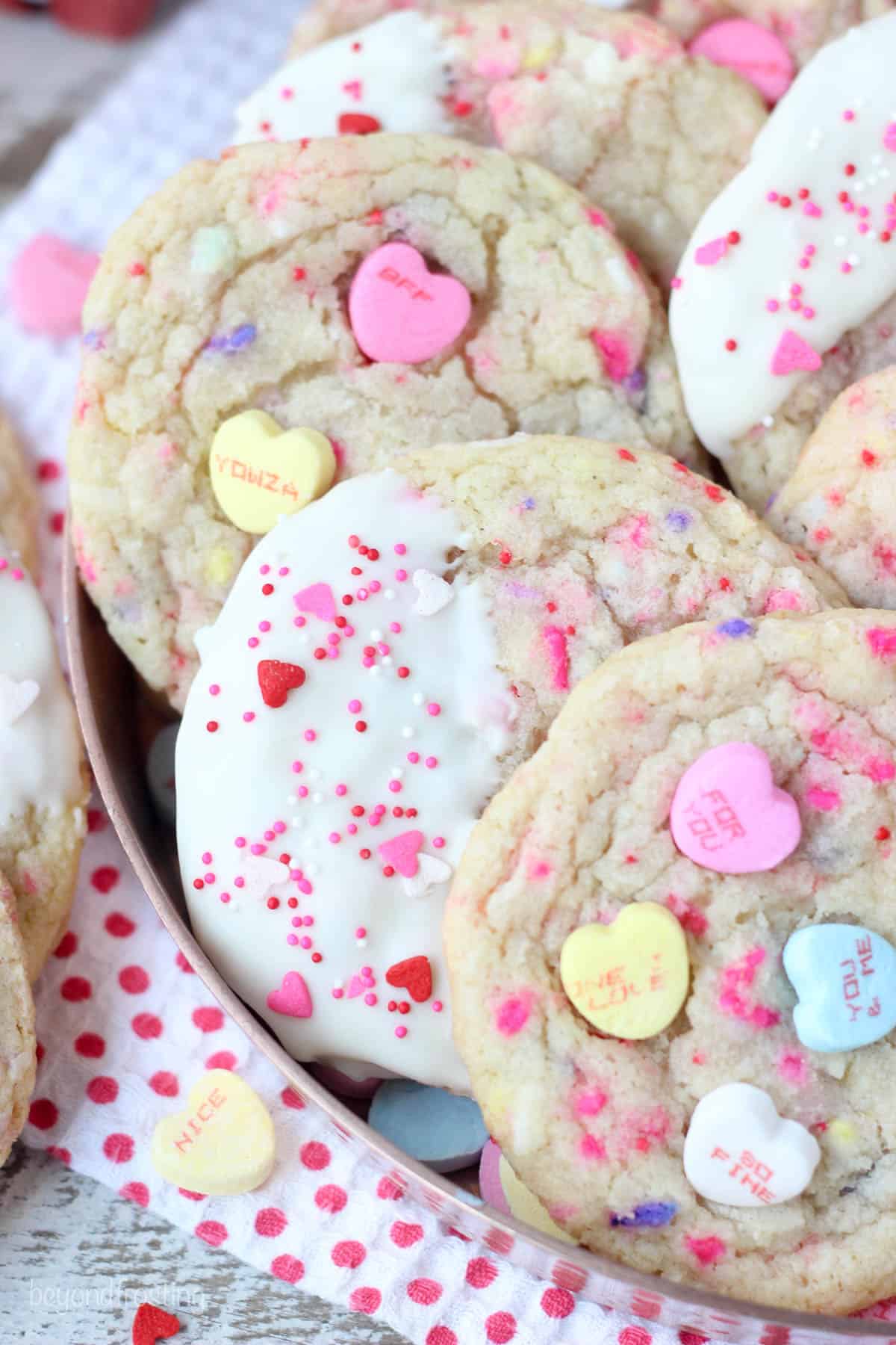 overhead shot of conversation heart sugar cookies layered into a serving dish