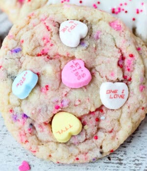 closeup of Valentine's Day sugar cookie decorated with conversation heart candies
