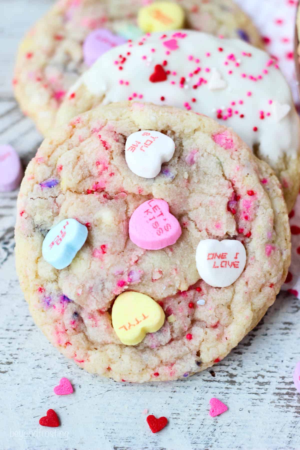 overhead shot of conversation heart cookie decorated with whole conversation hearts candy