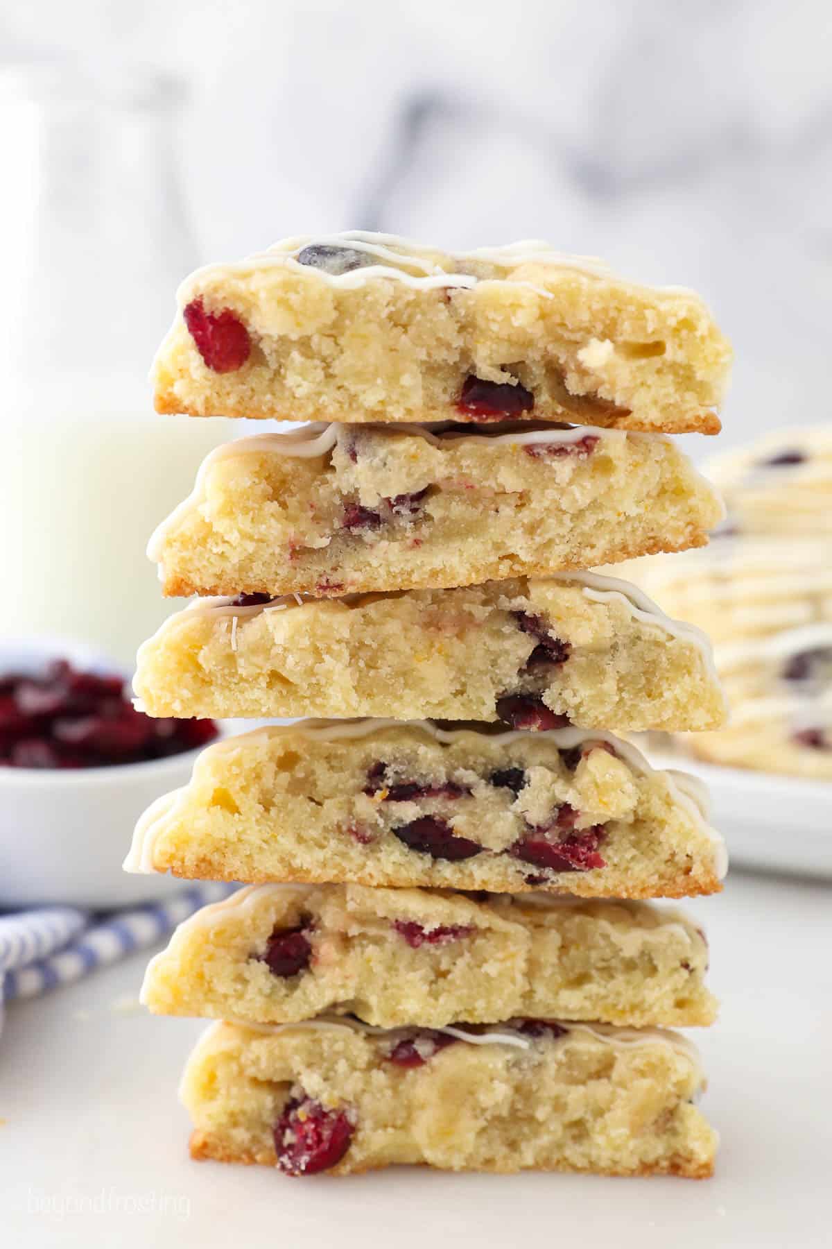 a stack of 6 halves of cookies, showing the inside stuffed with cranberries