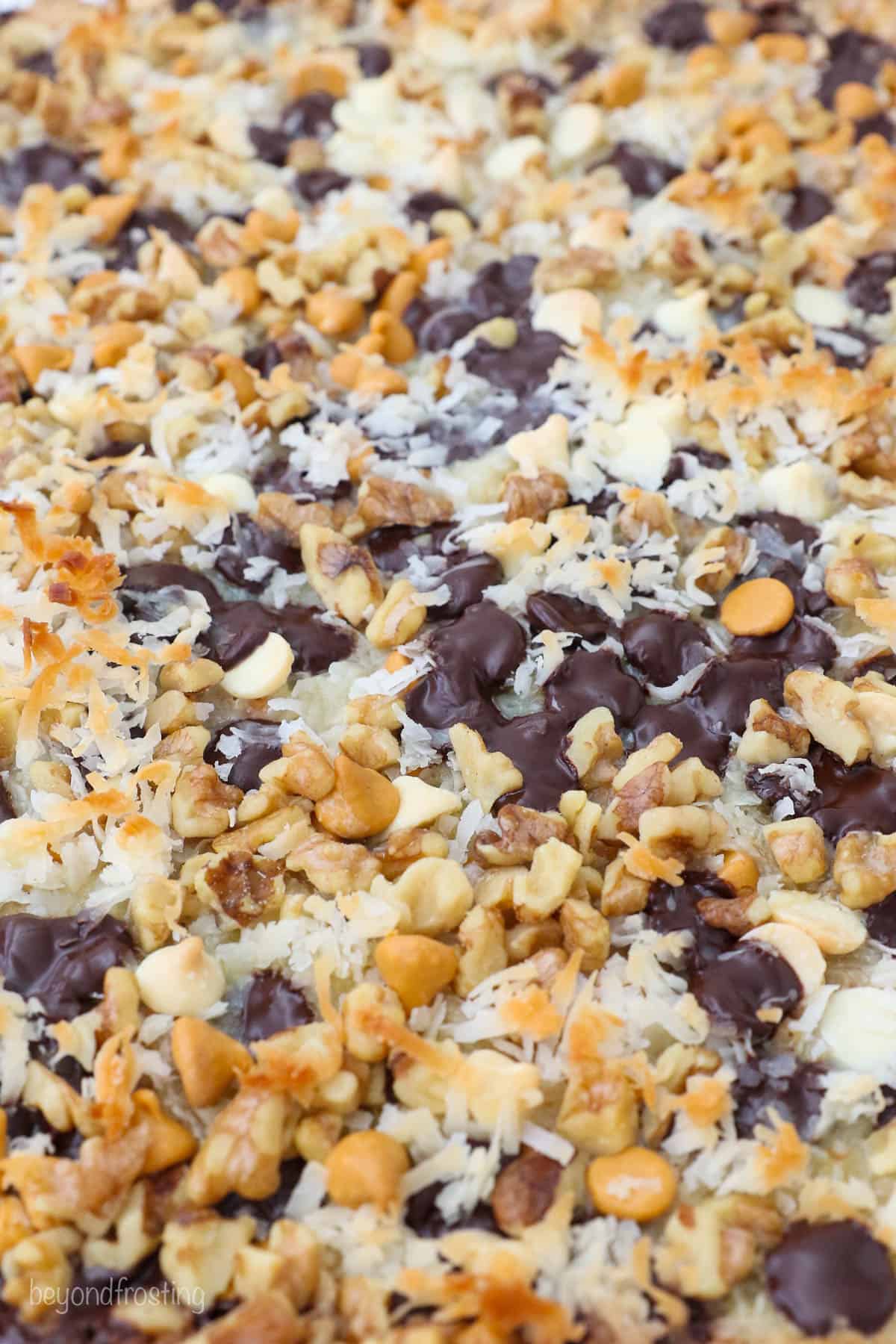 A close-up shot of the freshly-baked seven layer bars before they've been cut