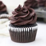 A close up of a chocolate cupcake decorated with chocolate frosting
