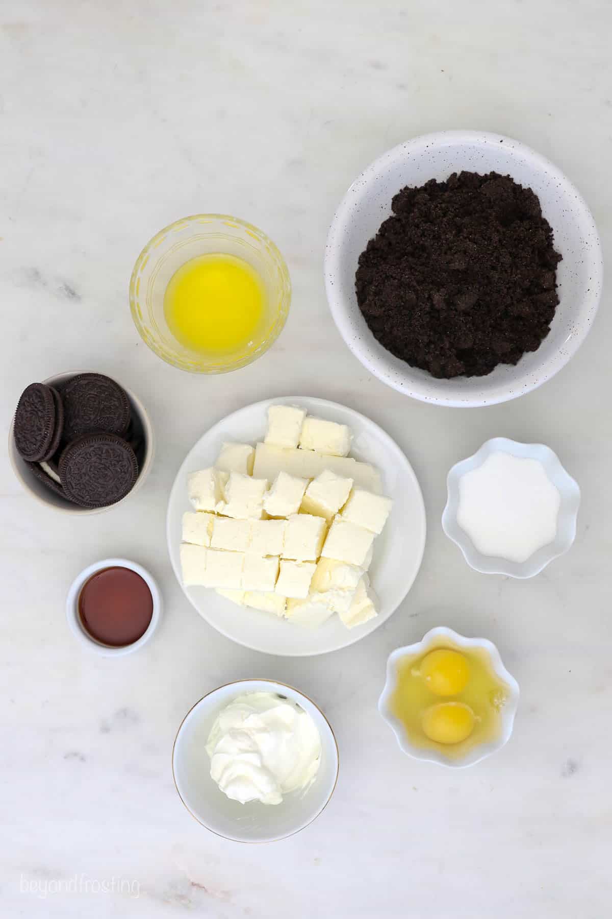 Eggs, butter, granulated sugar and the rest of the ingredients in small bowls on a kitchen countertop