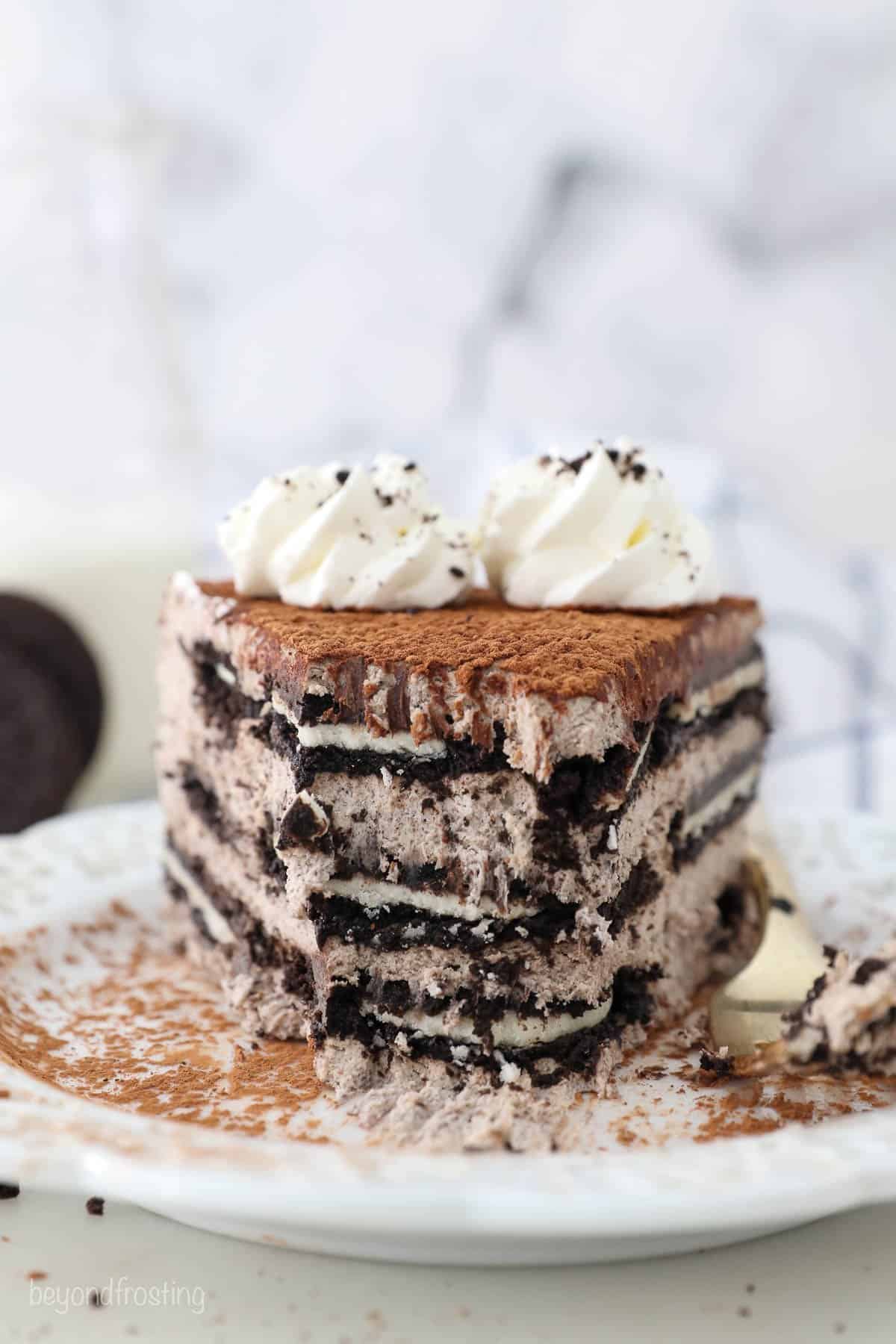 A slice of Oreo Mousse cake with a few bites missing, showing the inside of the cake