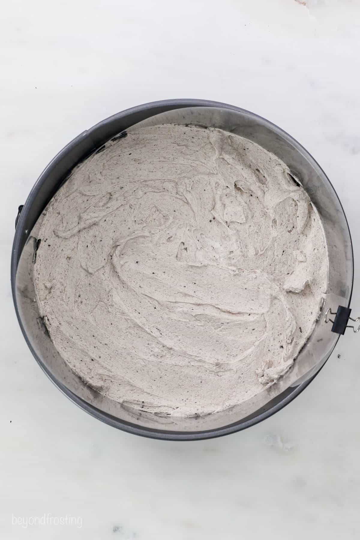 A look down into a pan with a layer of Oreo mousse