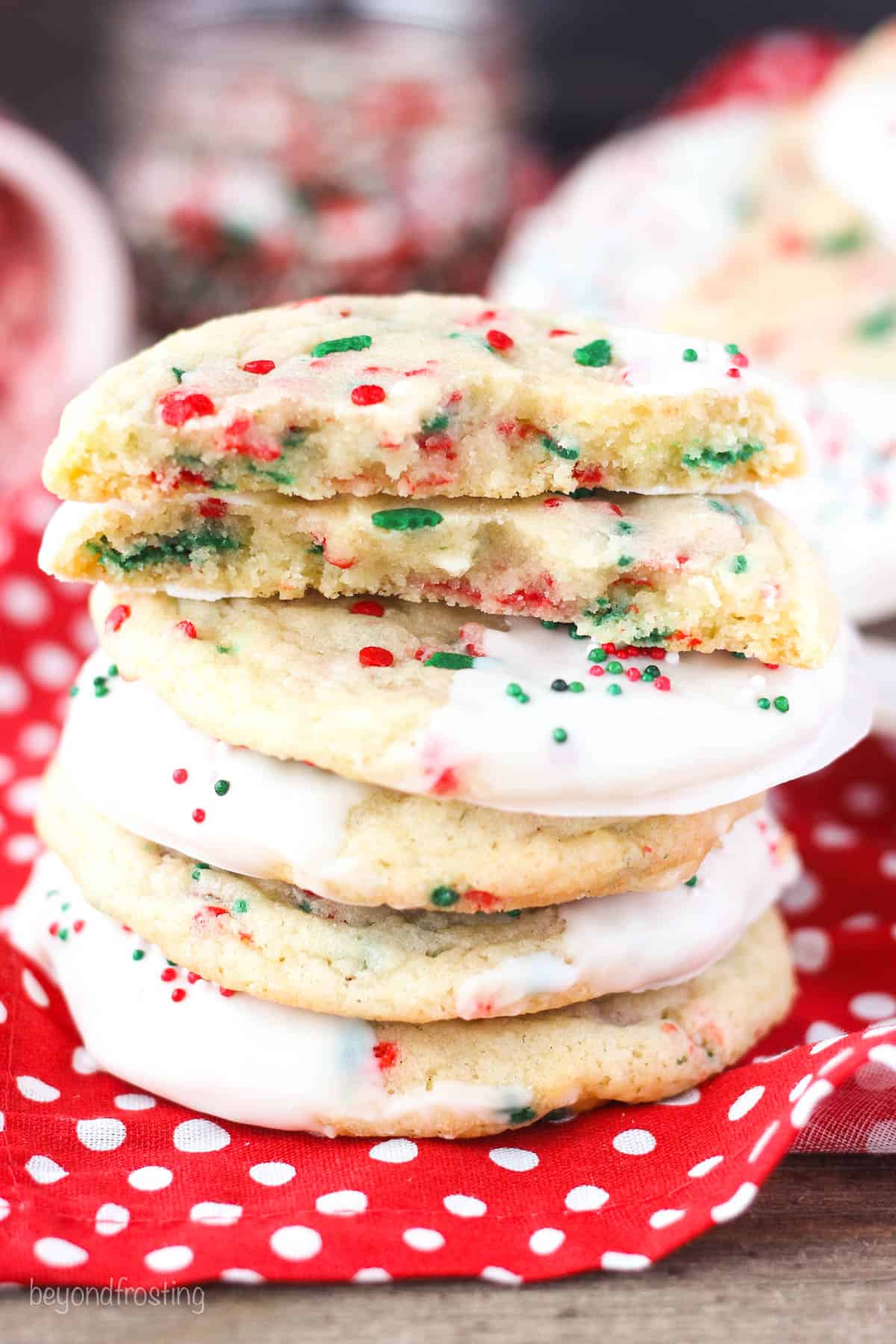 A stack of peppermint sugar cookies on a red and white polka dot napkin.