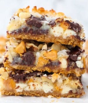 A stack of three 7-layer bars on a white countertop.