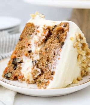 A close up of a thick slice of carrot cake