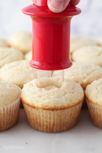 cupcake corer being used to remove the center of a coconut cupcake
