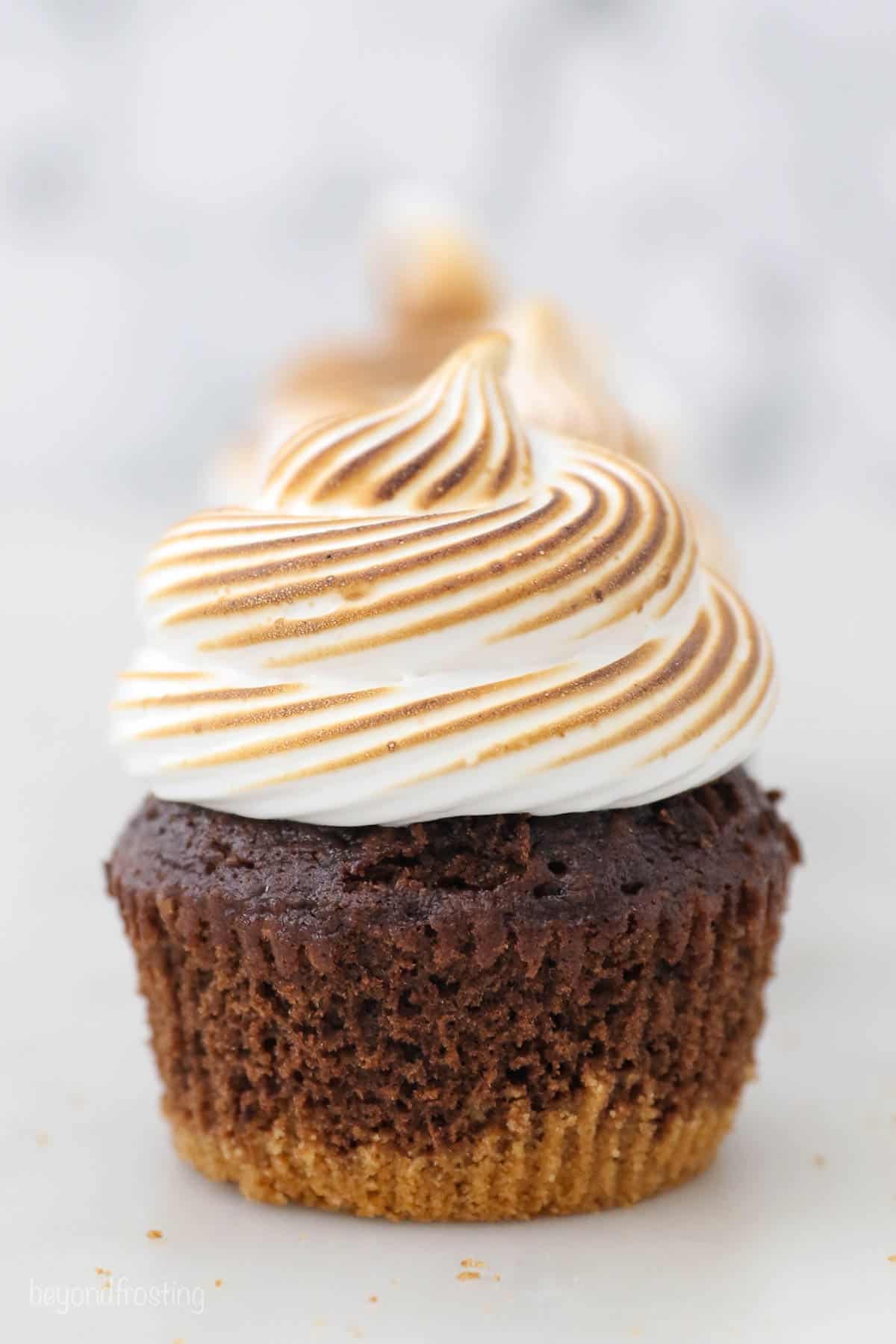 side view of a s'mores cupcake topped with toasted marshmallow frosting
