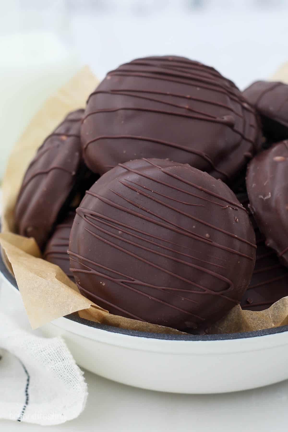 Chocolate coated Tagalong Cookies in a white dish