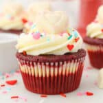A frosted Red Velvet cupcake decorated for Valentine's Day